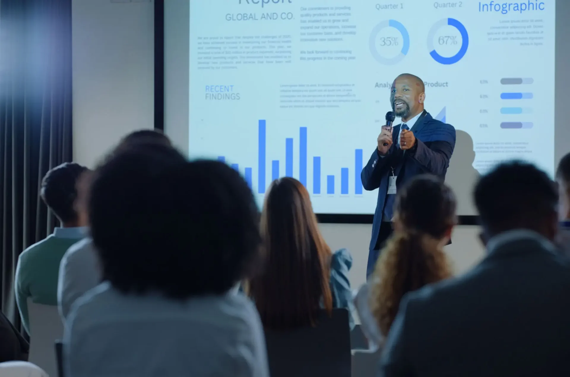 Businessman giving a presentation with charts to an audience.